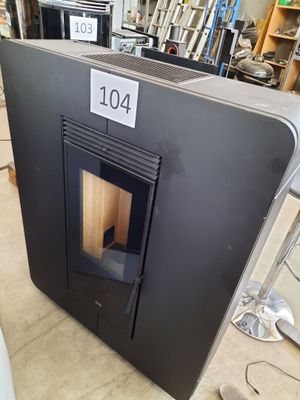 a black stove sitting in the middle of a room
