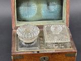 a wooden box with two glass dishes inside of it