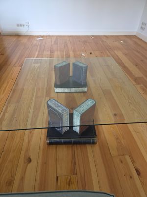a glass table with a book on it in the middle of a room
