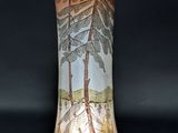 un vase en verre décoré d'une peinture, posé sur une table