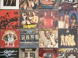 many different album covers on the wall of a room