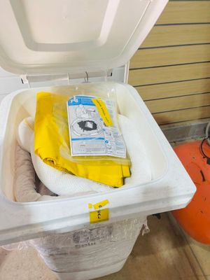 a white trash can with a yellow bag inside of it