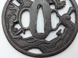 a metal plate with a dragon and a bird on it
