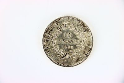 an old silver coin on a white surface