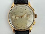 a close up of a watch on a white surface