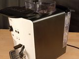 a black and white coffee maker on a wooden table