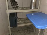 a blue table in the corner of a small room