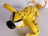 a yellow toy that is laying down on a table