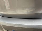 a toothbrush that is sitting on the front of a car