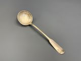 a close up of a spoon with a spoon handle on a gray surface