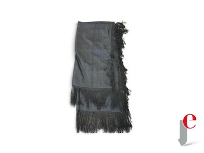 black fringed scarf on a white background with a red and white logo