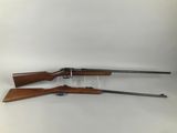 a pair of shotguns on a white background