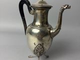 an antique silver teapot with a black handle on a white surface