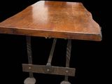 an image of a wooden table with metal legs on a black background