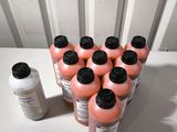several bottles of liquid sitting on top of a table next to a bottle of liquid
