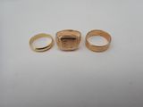 two gold rings and a ring with a picture of a man ' s face on it