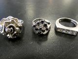 two rings and a ring on a table next to each other