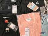 a lot of t - shirts that are on a table