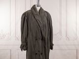 trench coat on a mannequin stand in a white room