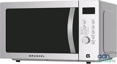 une photo d'un four à micro-ondes argenté avec une porte noire