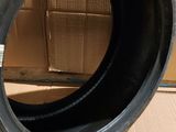 a close up of a tire on a cardboard box on a floor