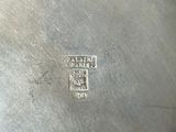 a metal pan that has a handle on it