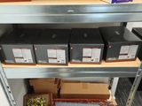 many boxes and boxes on a shelf in a room