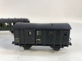 two toy train cars sitting on a white surface