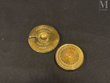 pair of antique brass plated pocket watches on a black background