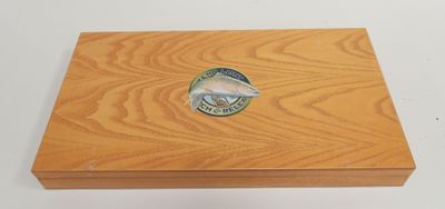 an image of a wooden box with a fish emblem on it