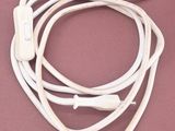 a pair of white ear buds attached to a white cord