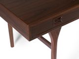 a small wooden table with a drawer on top of it
