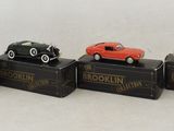 four toy cars sitting on top of a black box