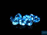a group of blue diamonds on a black surface