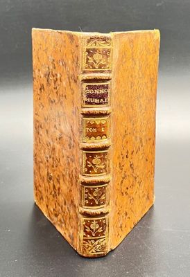 an old book sitting on top of a table next to a black table