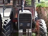 a tractor that is parked in front of a building