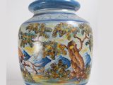 a blue and white vase with a painting on it