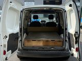 a white van with its doors open in a parking lot