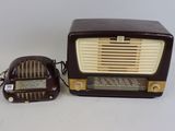 an old fashioned radio and a small speaker on a table