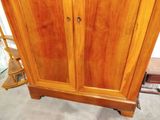 an image of a wooden armoire in a room
