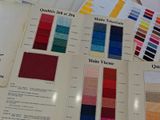 a lot of different colors of fabric on the table