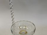 a glass candle holder with a candle inside of it