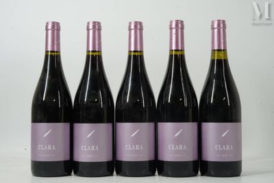 six bottles of wine are lined up in a row on a table