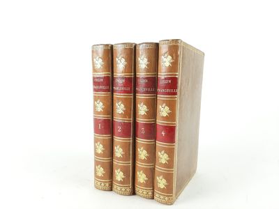 three books sitting on top of each other on a white surface