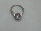 a close up of a diamond ring on a white surface