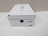a white box with gold writing on it sitting on a table