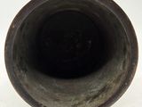 a close up of a vase on a white surface