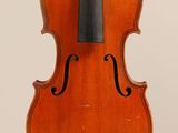 an old violin with a bow hanging from it ' s back