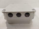 a white box with three holes on it on a table