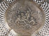 a silver plate with a picture of a man riding a horse